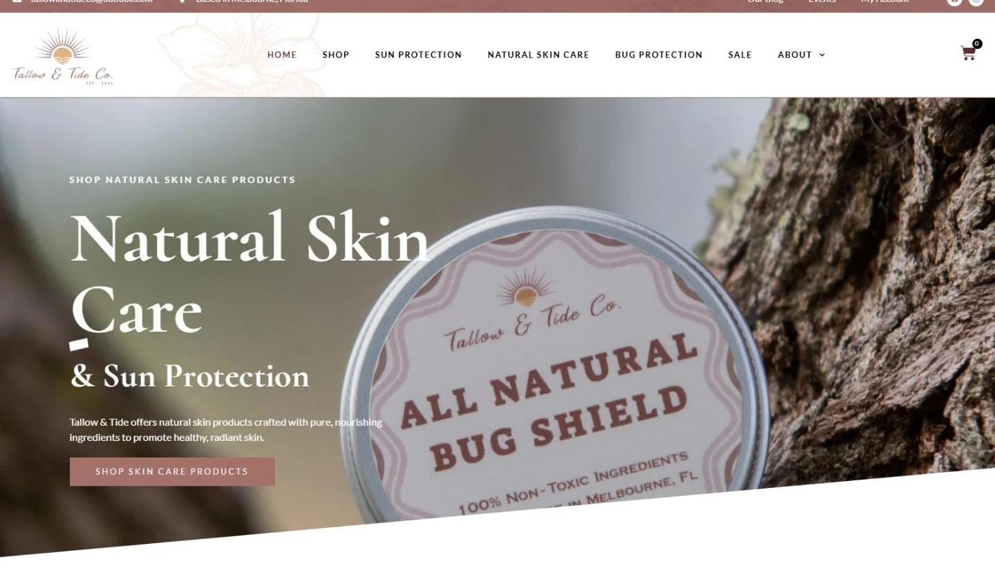 The second homepage slide: a tin of All Natural Bug Shield resting against tree bark, with the headline Natural Skin Care and Sun Protection mid transition and a Shop skin care products button